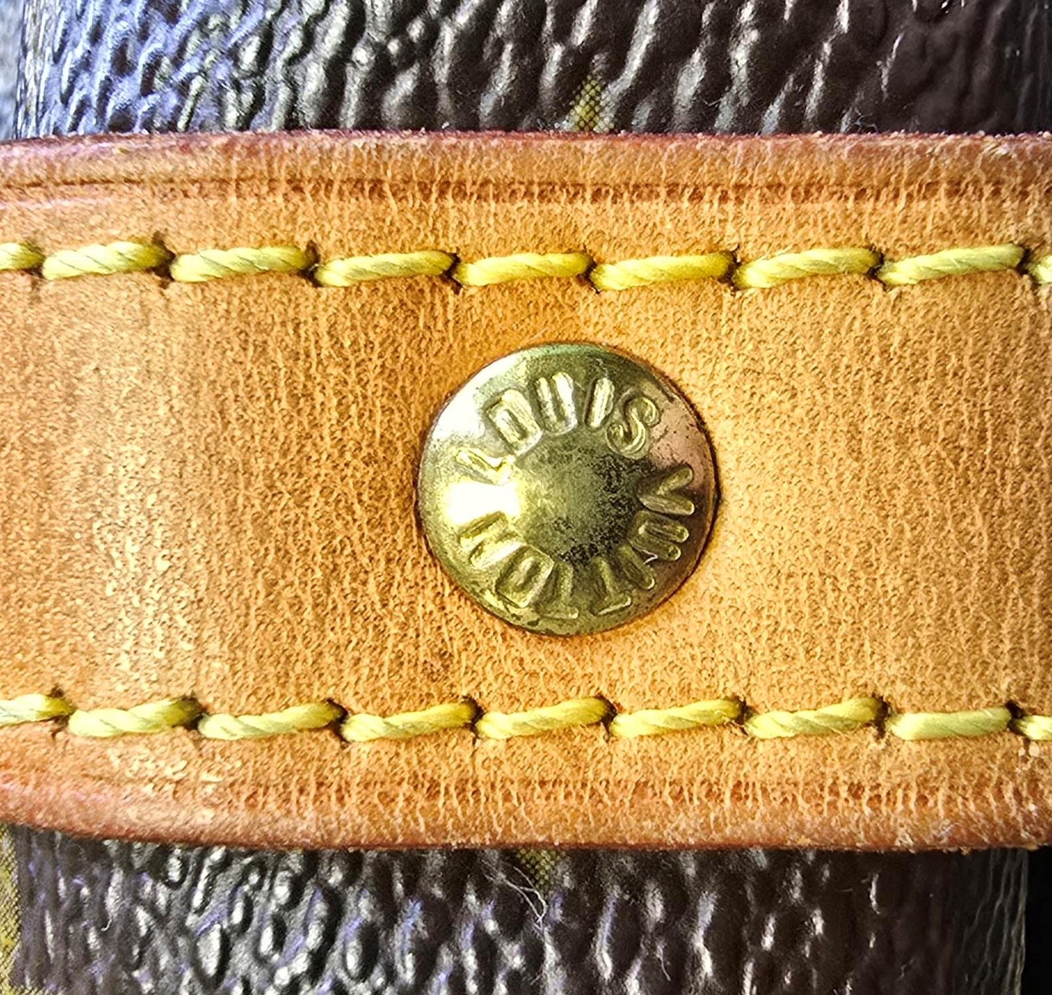 Close-up of authentic Louis Vuitton hardware and stitching used in authentication preview